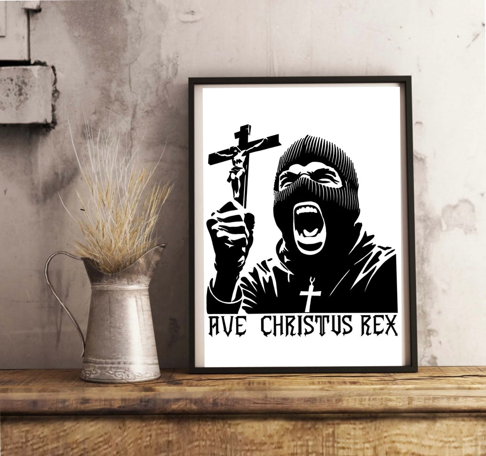 Introducing the "Ave Christus Rex Print"—a mesmerizing black and white masterpiece that captures an individual in a balaclava passionately holding up a crucifix. The striking phrase "AVE CHRISTUS REX" boldly adorns the bottom, adding to its commanding presence. This exquisite piece of religious art comes beautifully framed, ready to grace your space as it rests elegantly on a wooden floor against a clean white wall. Perfect for creating an inspiring focal point in any room!