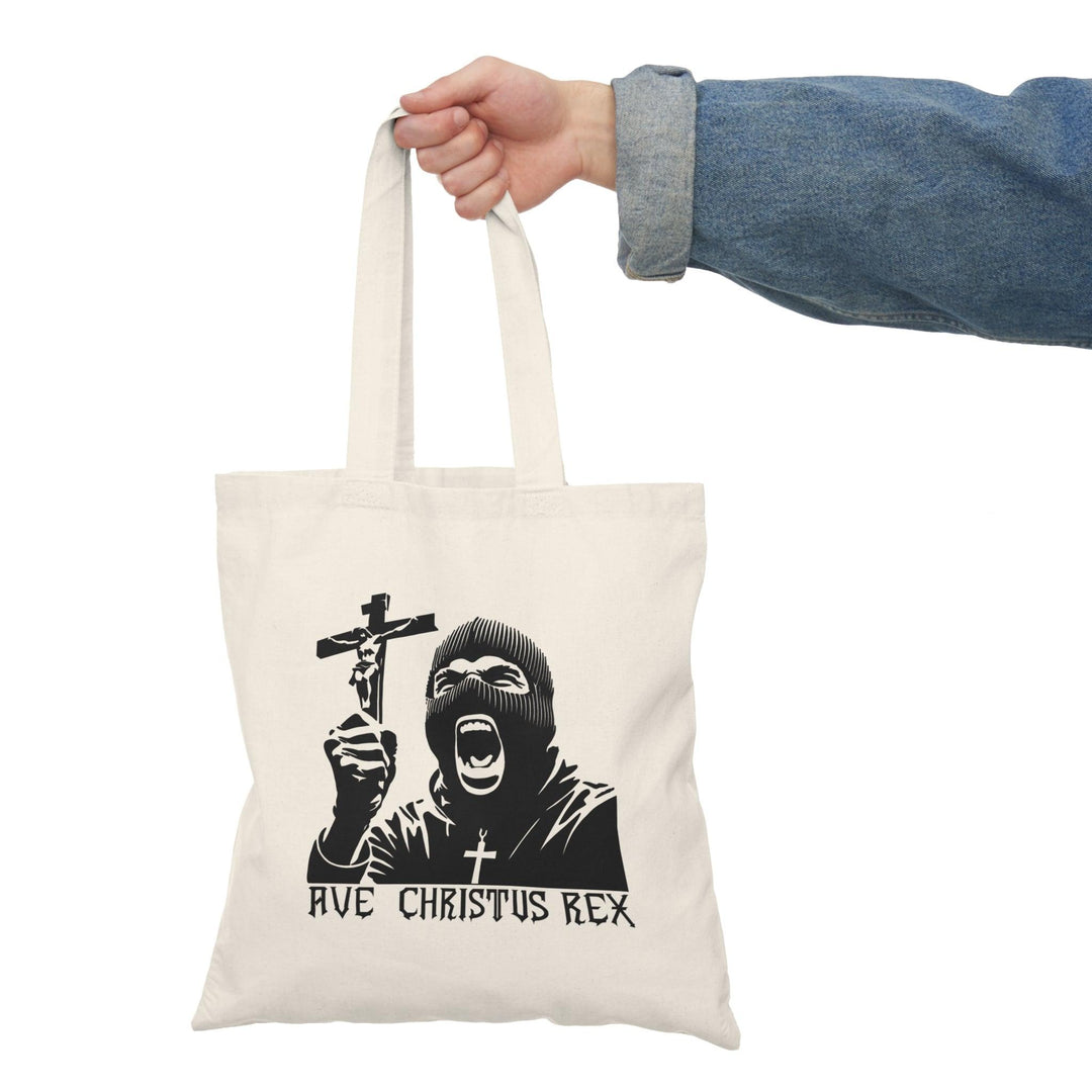 ote bag featuring a striking design with the phrase 'Ave Christus Rex' prominently displayed. The artwork combines bold typography with artistic elements that evoke a sense of faith and reverence, making it a unique accessory for expressing spiritual devotion and style