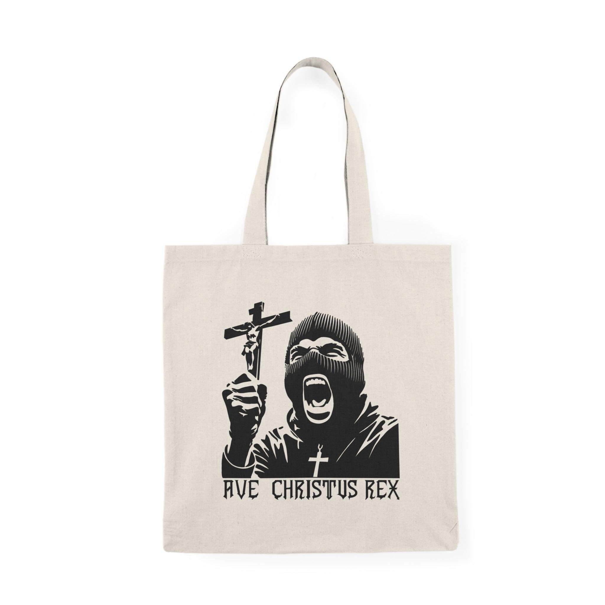 ote bag featuring a striking design with the phrase 'Ave Christus Rex' prominently displayed. The artwork combines bold typography with artistic elements that evoke a sense of faith and reverence, making it a unique accessory for expressing spiritual devotion and style