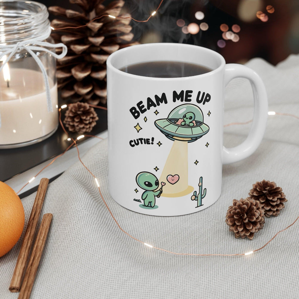 Fun and playful white ceramic mug with alien illustrations and the cheeky text 'Beam Me Up, Cutie!,' giving your morning a cosmic lift