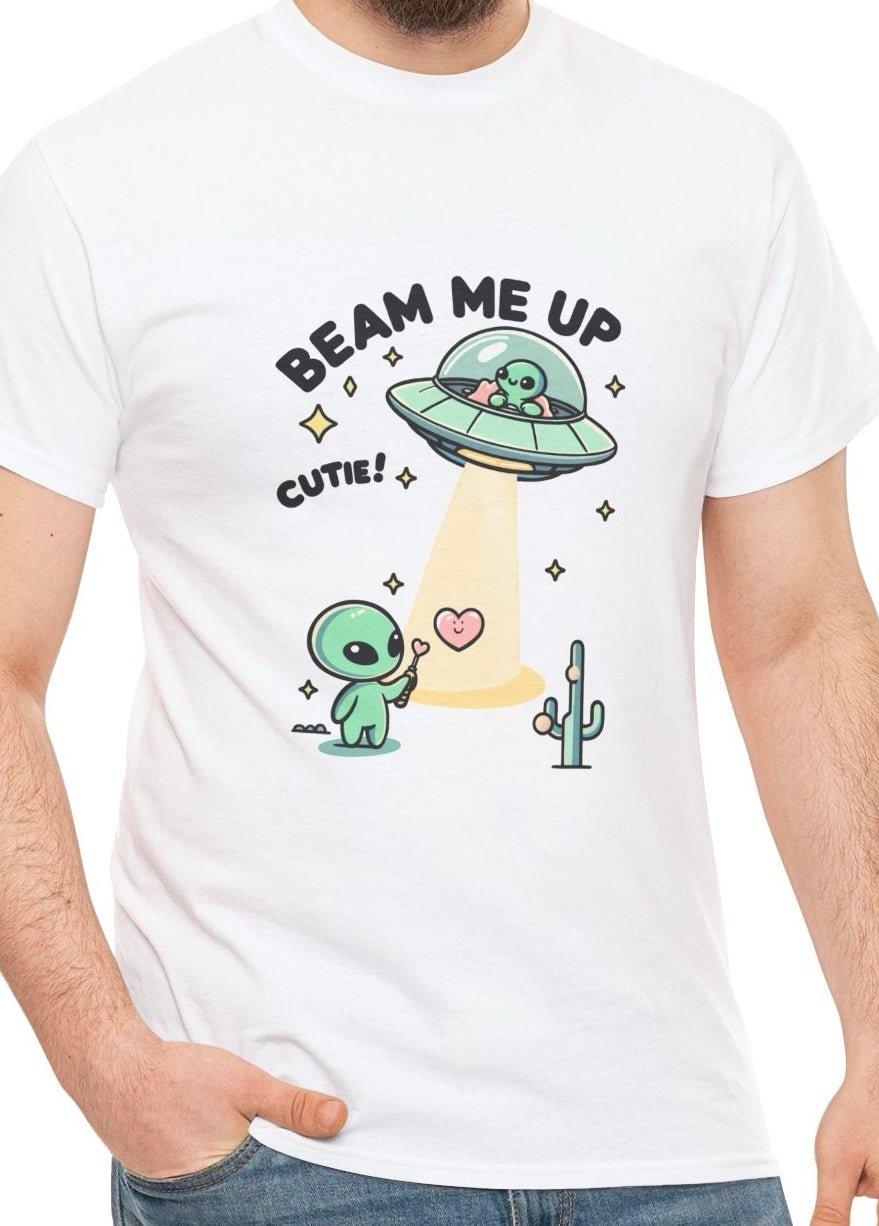White T-shirt featuring an adorable alien in a flying saucer beaming up a cartoon character, with the playful text 'Beam Me Up, Cutie!' A fun and light-hearted design for lovers of sci-fi and cute illustrations."