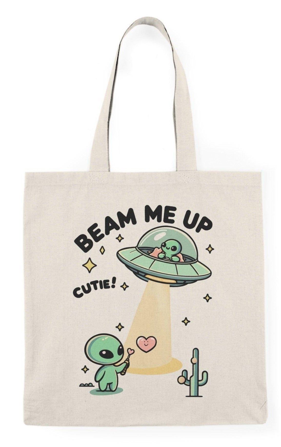 Tote bag featuring a whimsical design with the phrase 'Beam Me Up, Cutie' alongside a charming illustration of a cute alien. The colorful and playful graphics create a fun and quirky vibe, making it an ideal accessory for those who love all things cosmic and adorable."  KEOLIX