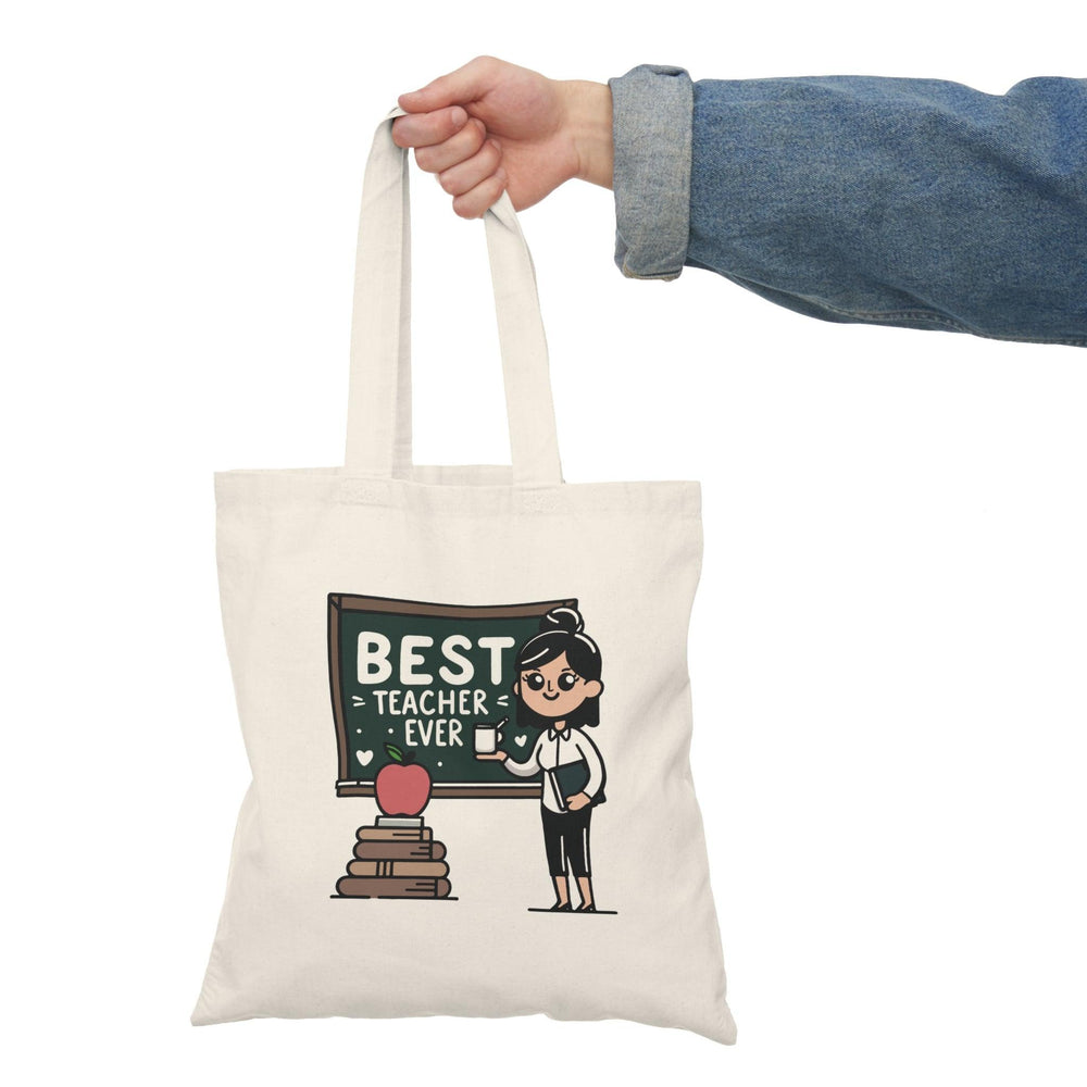 Tote bag featuring a cheerful design with the phrase 'Best Teacher Ever' surrounded by colorful school-themed graphics, including books and apples. This vibrant and heartfelt design makes it a perfect gift for educators, celebrating their dedication and impact in a fun and stylish way.