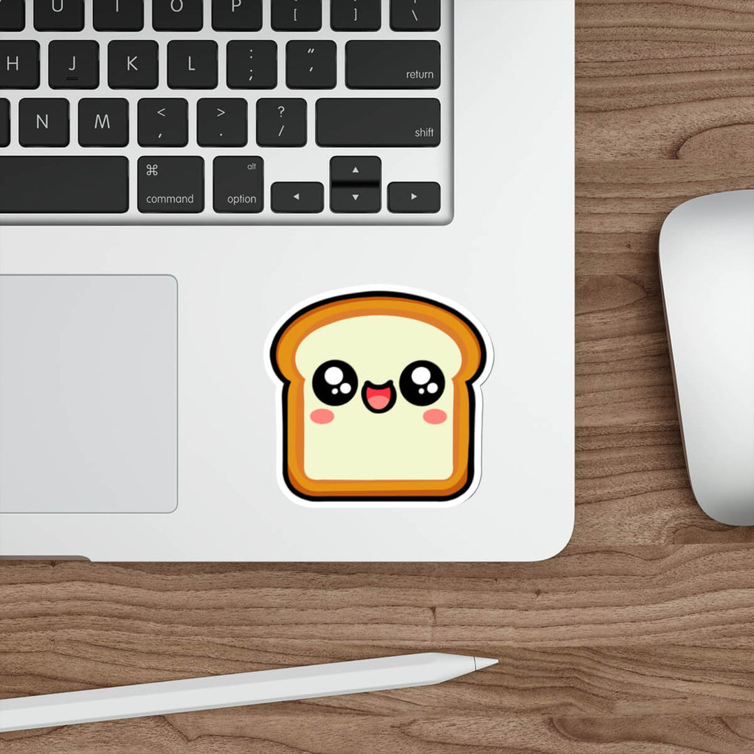 Kawaii-style bread slice sticker with a happy, blushing face placed on a laptop. A fun, cute decal perfect for decorating tech, notebooks, or water bottles