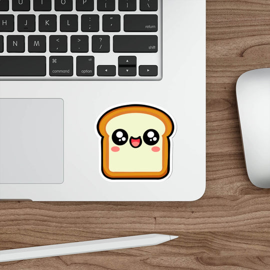 Kawaii-style bread slice sticker with a happy, blushing face placed on a laptop. A fun, cute decal perfect for decorating tech, notebooks, or water bottles