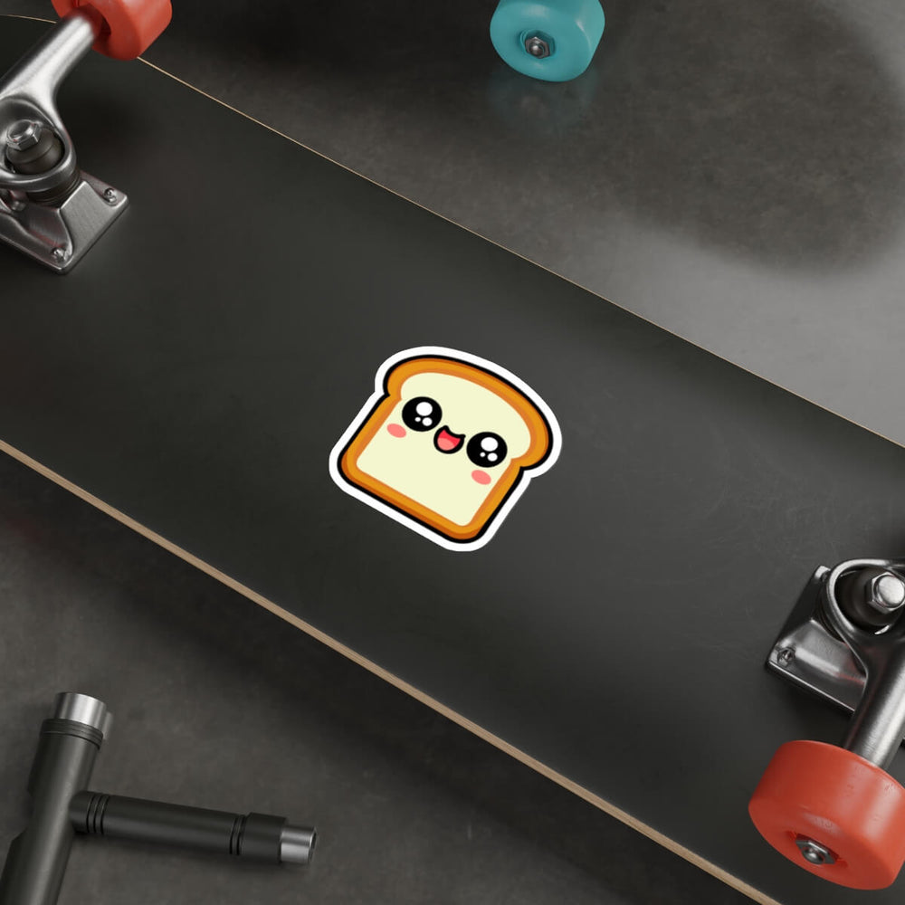 Kawaii-style bread slice sticker with a happy, blushing face placed on a laptop. A fun, cute decal perfect for decorating tech, notebooks, or water bottles