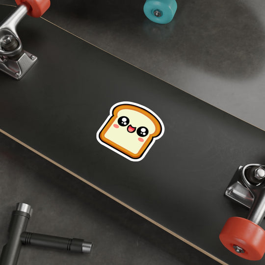 Kawaii-style bread slice sticker with a happy, blushing face placed on a laptop. A fun, cute decal perfect for decorating tech, notebooks, or water bottles