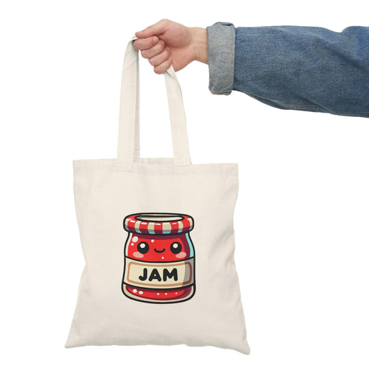 A cheerful tote bag featuring a kawaii-style illustration of a smiling jam jar with a red and white striped lid on a light beige background