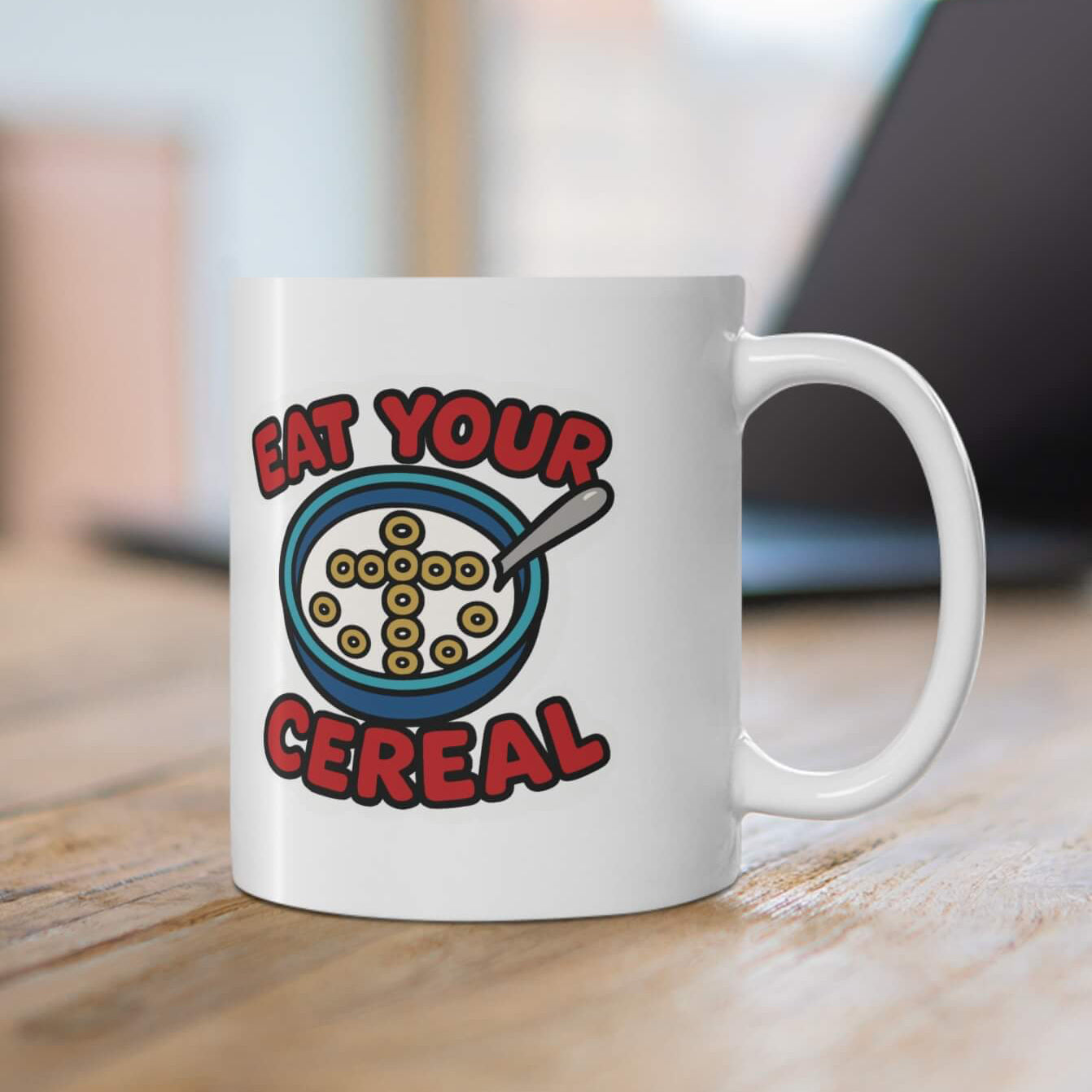 White mug with a colorful design on a wooden surface
