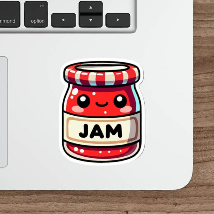Cute kawaii-style jam jar sticker with a smiling face, red and white stripes, and the word 'JAM' on a laptop next to a mouse and pencil.
