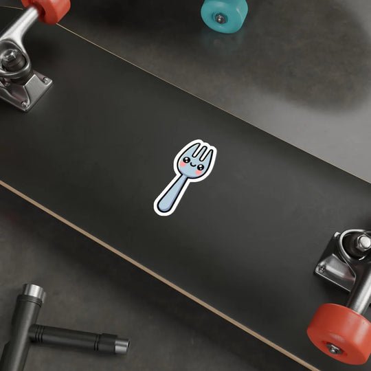 A cute and playful die-cut spork sticker featuring a smiling cartoon spork with rosy cheeks. The sticker has a bold black outline and is designed for durability, making it ideal for decorating laptops, notebooks, water bottles, and more. Available as a single sticker, a pack of 3, or a pack of 6. Waterproof and long-lasting.