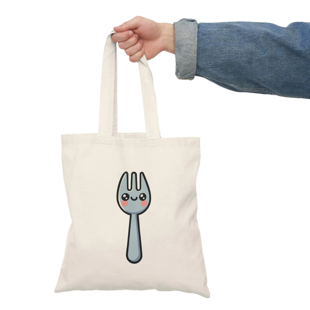 A natural-colored tote bag featuring a cute, smiling spork illustration with rosy cheeks. Made from 100% recycled cotton, this eco-friendly bag measures 40 x 38 cm (15.7 x 15 inches) and has a lightweight yet durable 130-135 gsm thickness. Perfect for shopping, carrying books, or everyday essentials.

