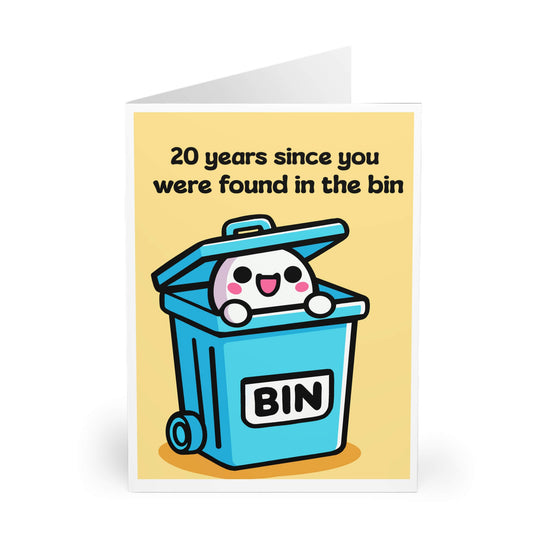 A humorous, customizable greeting card featuring a cute cartoon character popping out of a blue trash bin with "BIN" written on it. The text reads, "20 years since you were found in the bin," with the option to personalize the age