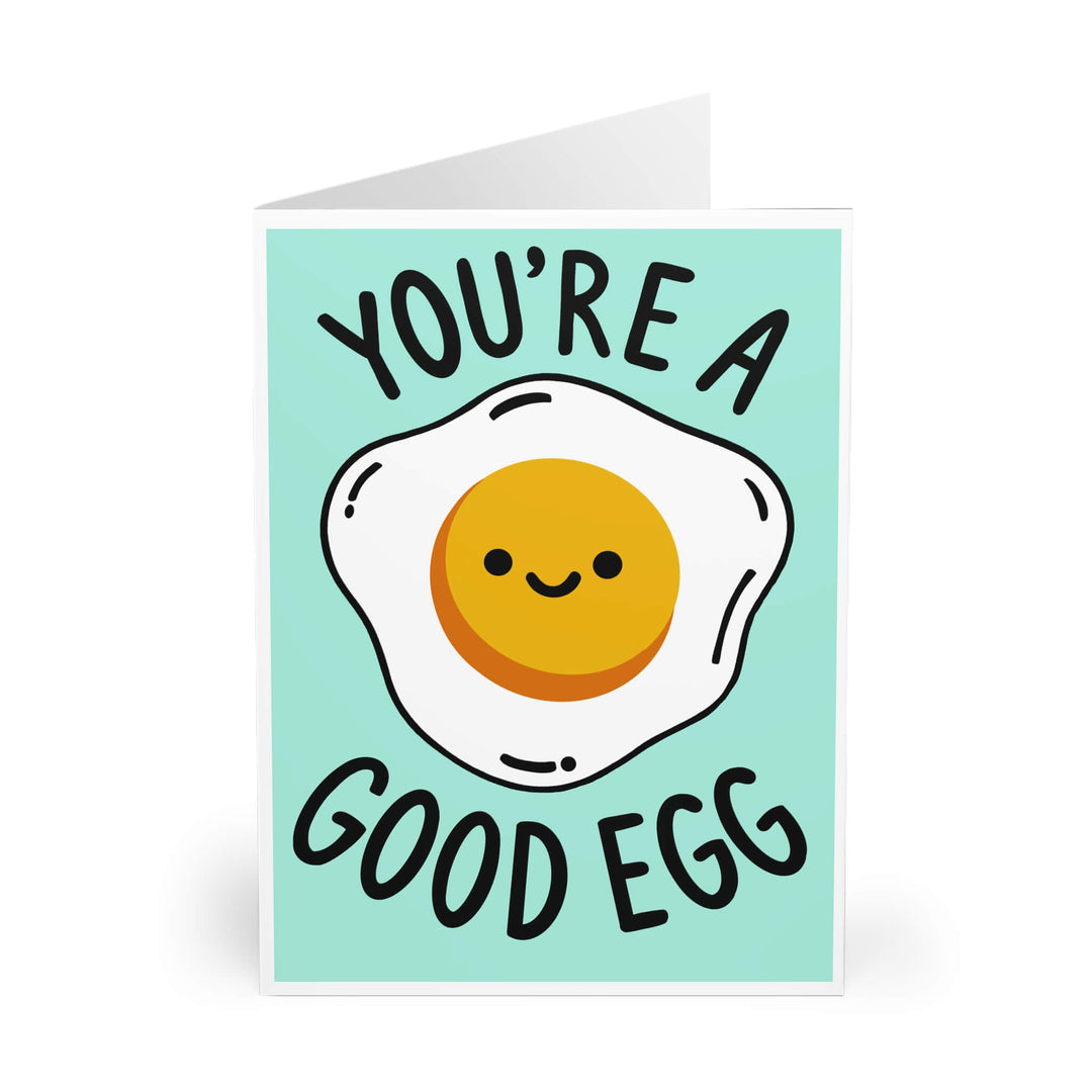 Greeting card with a smiley egg illustration and text 'You're a good egg' on a light blue background.