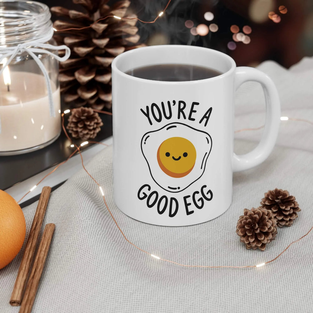 A ceramic mug with a glossy finish featuring a cheerful fried egg design and the phrase "You're a Good Egg." Perfect for coffee, tea, or gifting.

