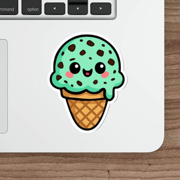 Cute mint chocolate chip ice cream sticker with kawaii smiley face, chocolate chip details, waffle cone base, on white background. KEOLIX 