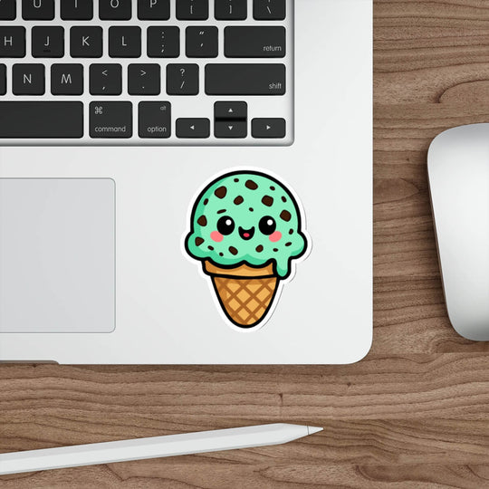 Cute mint chocolate chip ice cream sticker with kawaii smiley face, chocolate chip details, waffle cone base, on white background.