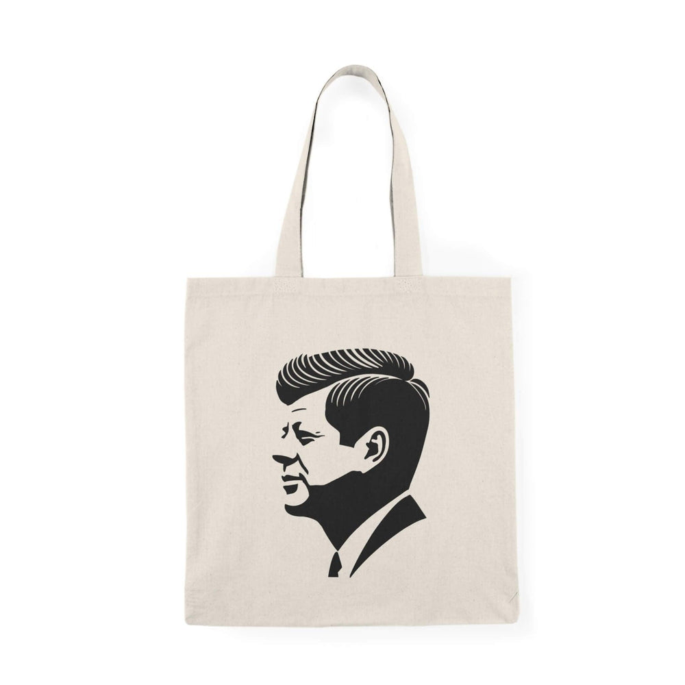 A stylish tote bag featuring a minimalist black silhouette of John F. Kennedy in profile, printed on natural recycled cotton. Optionally available with a subtle USA flag background design. Perfect for carrying essentials in a sleek, iconic style.

