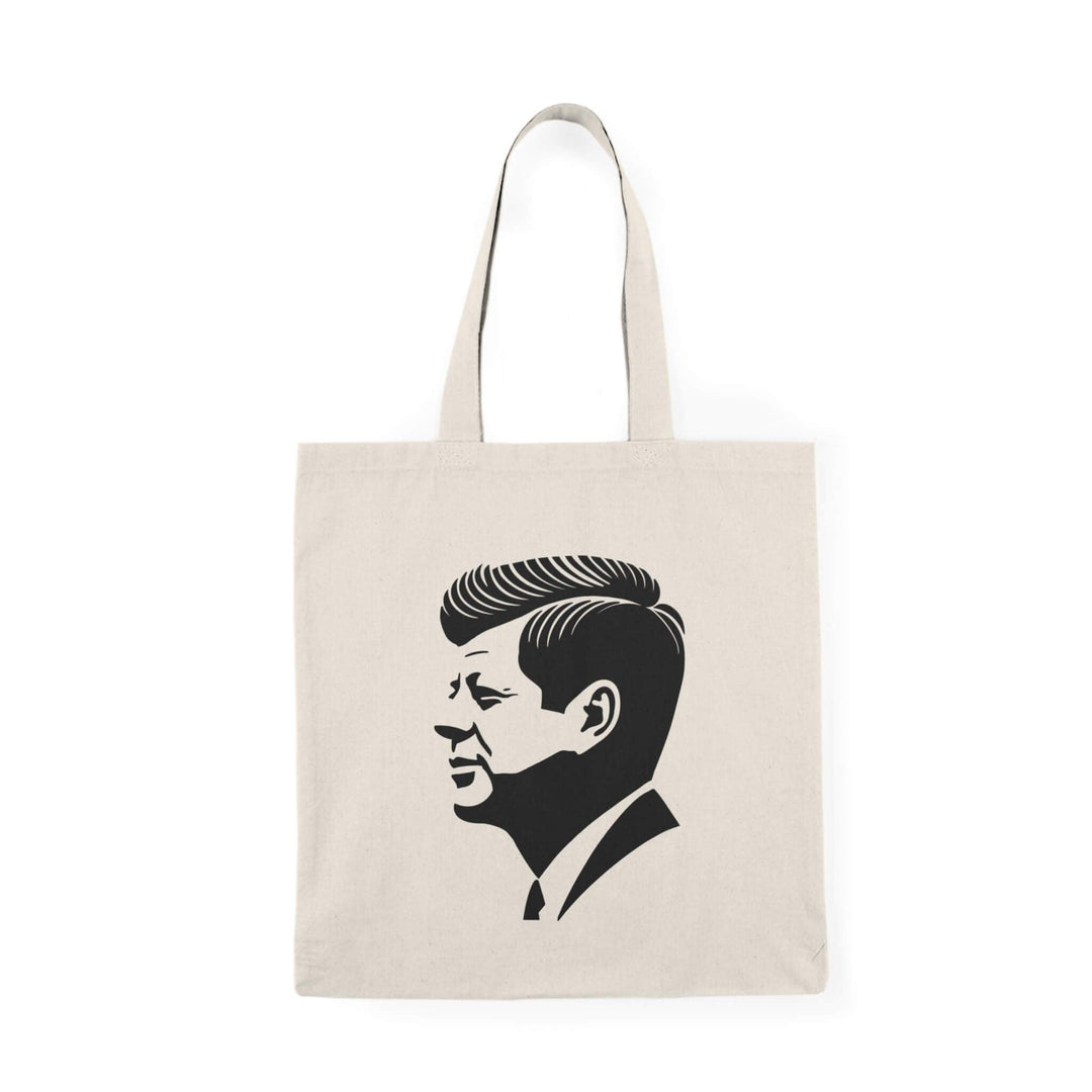 A stylish tote bag featuring a minimalist black silhouette of John F. Kennedy in profile, printed on natural recycled cotton. Optionally available with a subtle USA flag background design. Perfect for carrying essentials in a sleek, iconic style.

