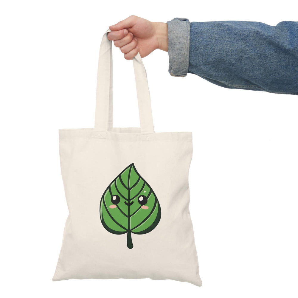 Kawaii leaf tote bag featuring a smiling, cute green leaf design. A perfect accessory for nature lovers and those who enjoy fun, playful designs.