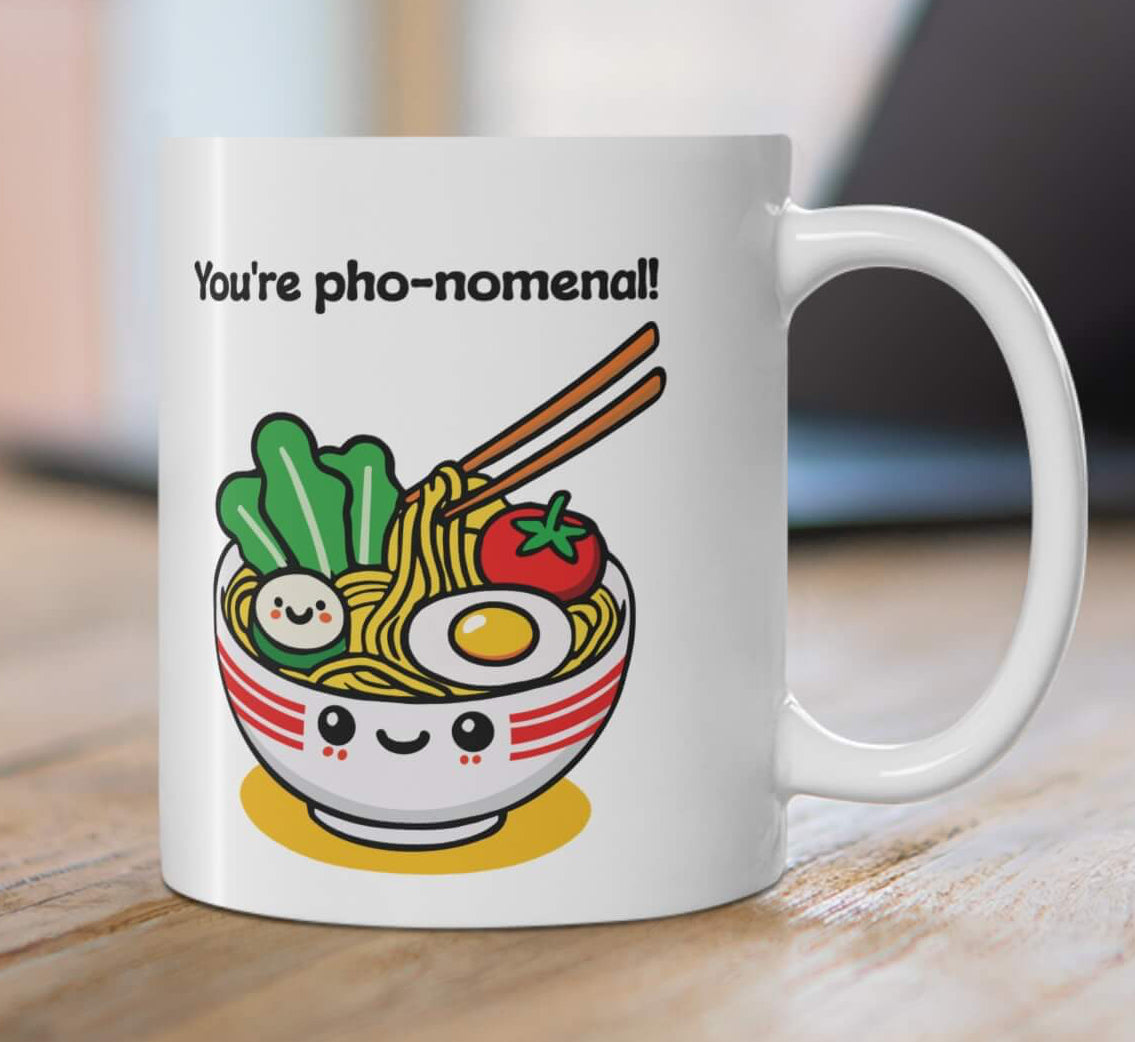 You're pho-nomenal!" mug featuring a kawaii-style smiling bowl of pho, with noodles, veggies, and an egg. A perfect gift for pho lovers and fun mug collectors.