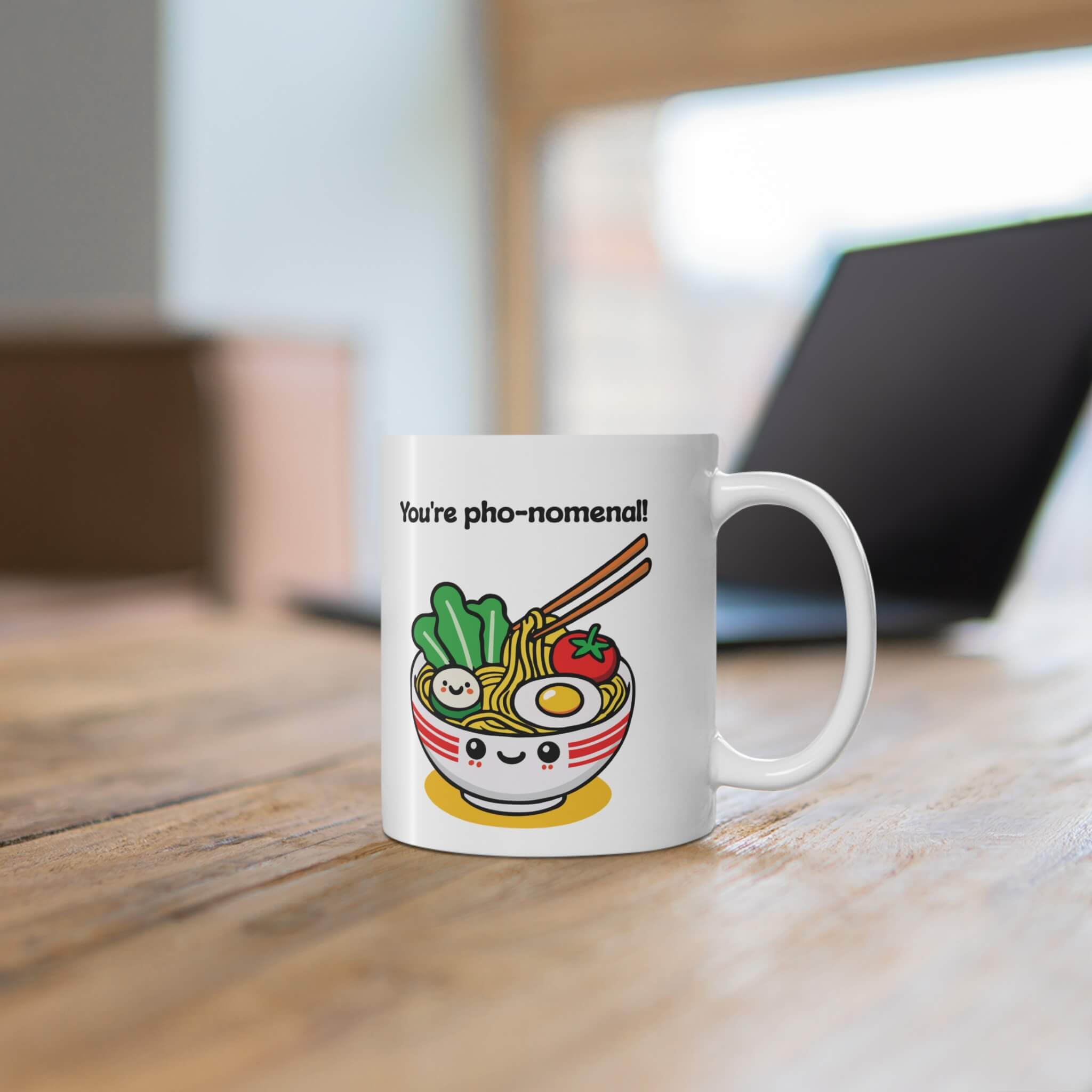 You're pho-nomenal!" mug featuring a kawaii-style smiling bowl of pho, with noodles, veggies, and an egg. A perfect gift for pho lovers and fun mug collectors.