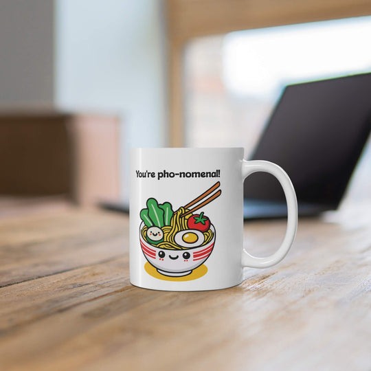 You're pho-nomenal!" mug featuring a kawaii-style smiling bowl of pho, with noodles, veggies, and an egg. A perfect gift for pho lovers and fun mug collectors.