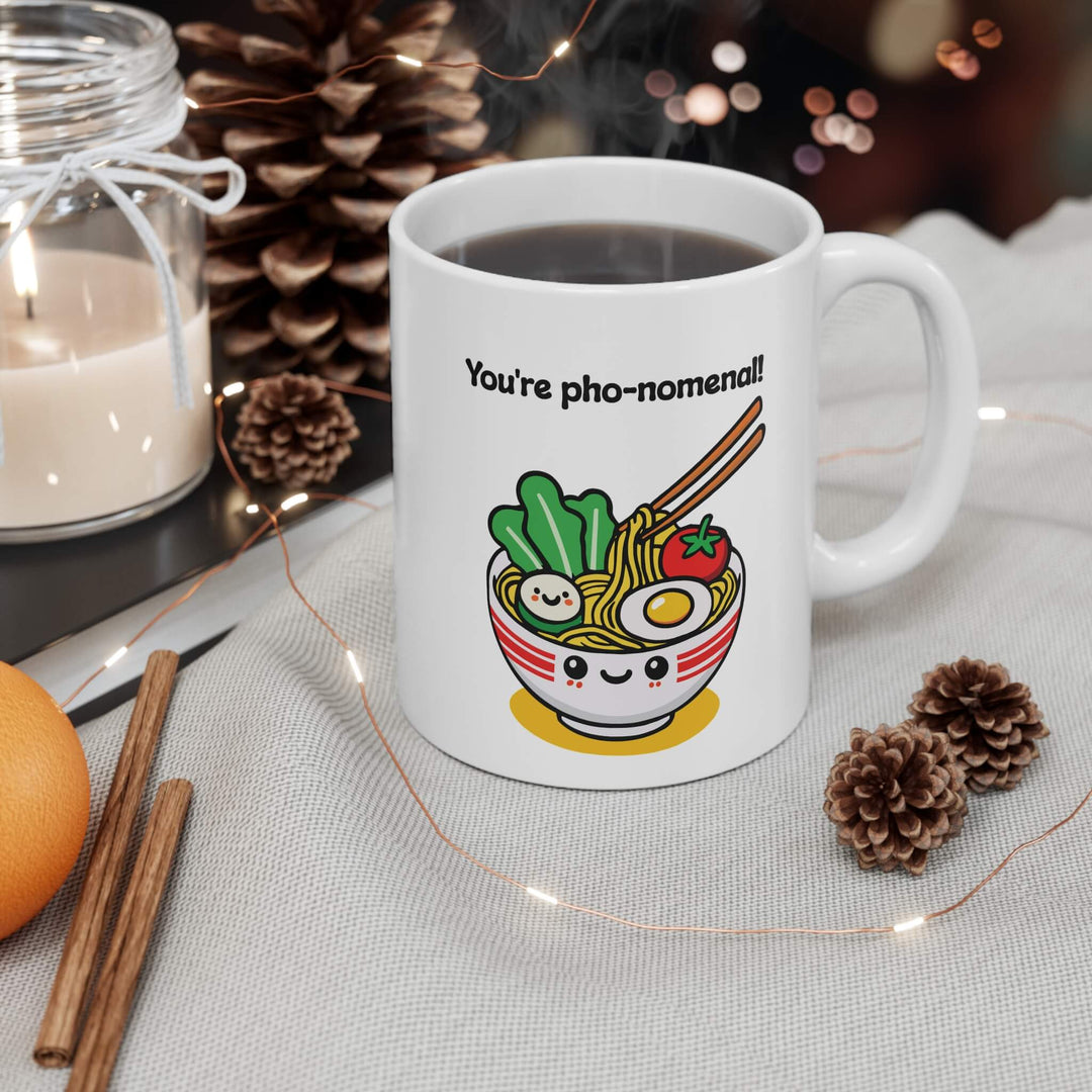 You're pho-nomenal!" mug featuring a kawaii-style smiling bowl of pho, with noodles, veggies, and an egg. A perfect gift for pho lovers and fun mug collectors.