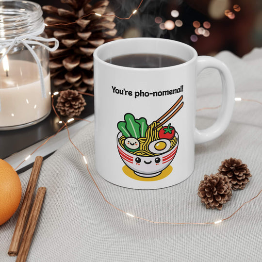You're pho-nomenal!" mug featuring a kawaii-style smiling bowl of pho, with noodles, veggies, and an egg. A perfect gift for pho lovers and fun mug collectors.