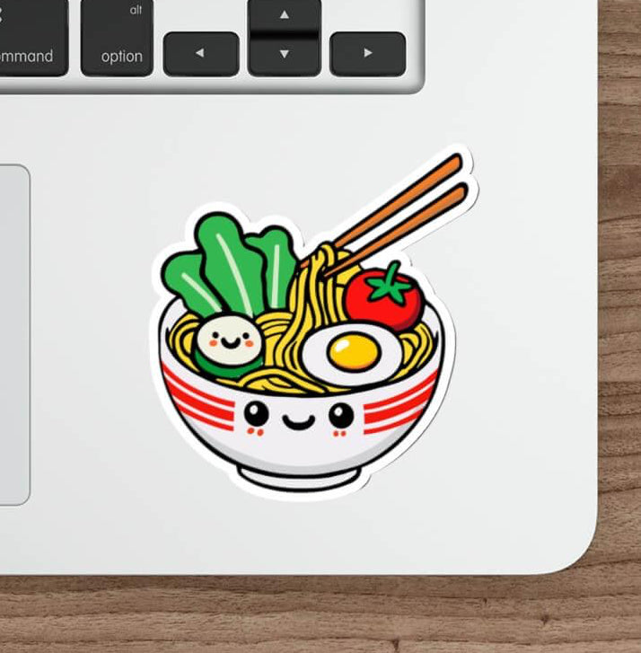 Kawaii pho sticker featuring a smiling bowl of pho with noodles, veggies, and an egg. Available as a single sticker, or in packs of 3 or 6. Perfect for food lovers.