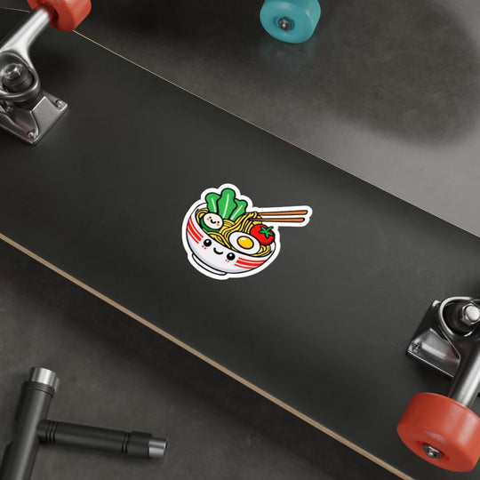 Kawaii pho sticker featuring a smiling bowl of pho with noodles, veggies, and an egg. Available as a single sticker, or in packs of 3 or 6. Perfect for food lovers.