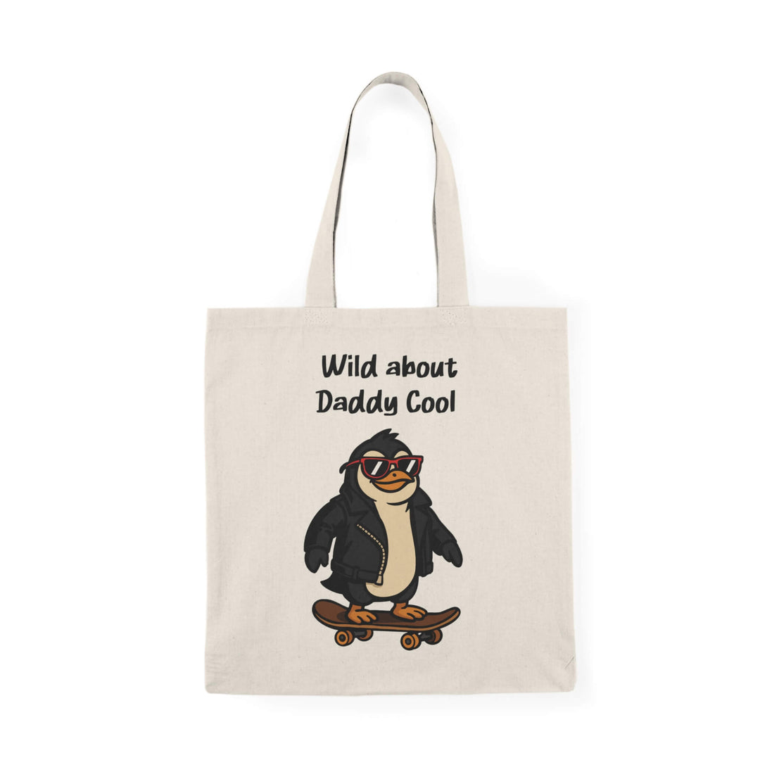 Tote bag with a cartoon penguin wearing red sunglasses and a leather jacket, riding a skateboard, with the text “Wild about Daddy Cool” above.
