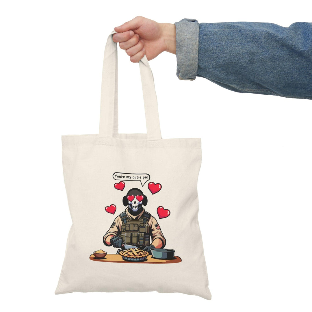 Tote bag featuring a playful illustration of a fearless soldier baking an apple pie, accompanied by the affectionate phrase 'You're My Cutie Pie.' The design combines elements of charm and humor, making it a perfect accessory for expressing love and sweetness in everyday life