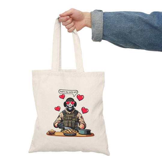 Tote bag featuring a playful illustration of a fearless soldier baking an apple pie, accompanied by the affectionate phrase 'You're My Cutie Pie.' The design combines elements of charm and humor, making it a perfect accessory for expressing love and sweetness in everyday life