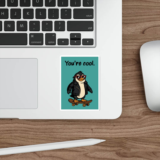 Laptop with a penguin sticker on a wooden desk